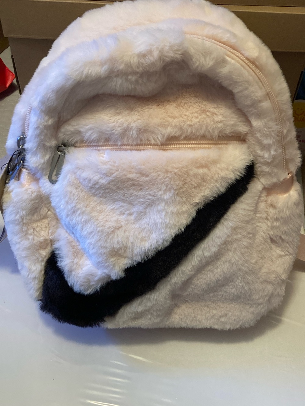 Nike Plush Faux Fur Backpack in Light Pink with Black Swoosh